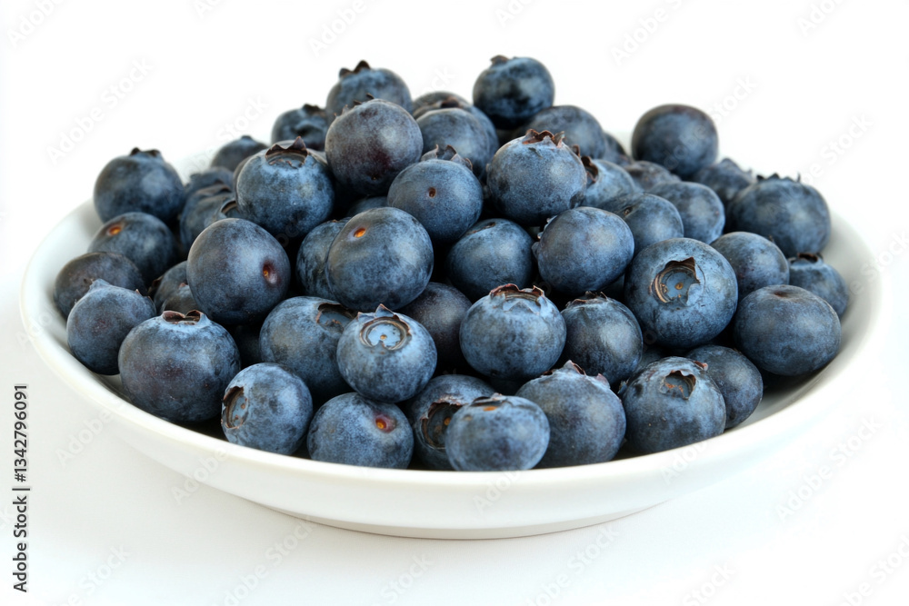 There is a white plate with blueberries on it on a white surface There is a white plate with blueberries on it on a white surface