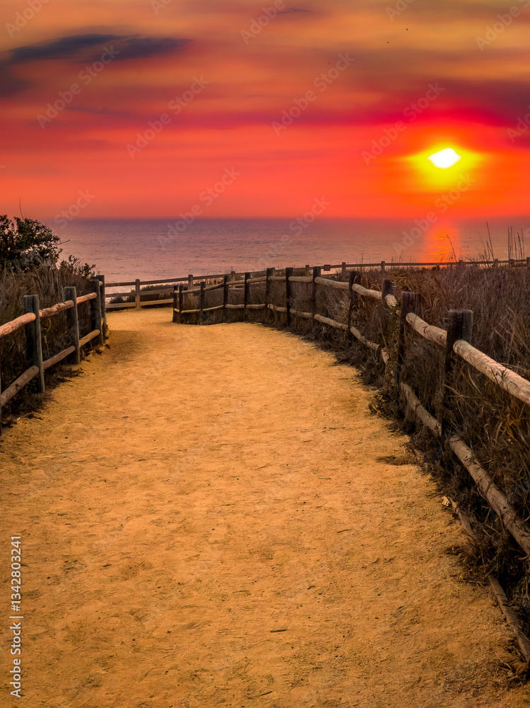 Coastal trail with full ocean view and dramatic colorful sky along the Southern California shoreline