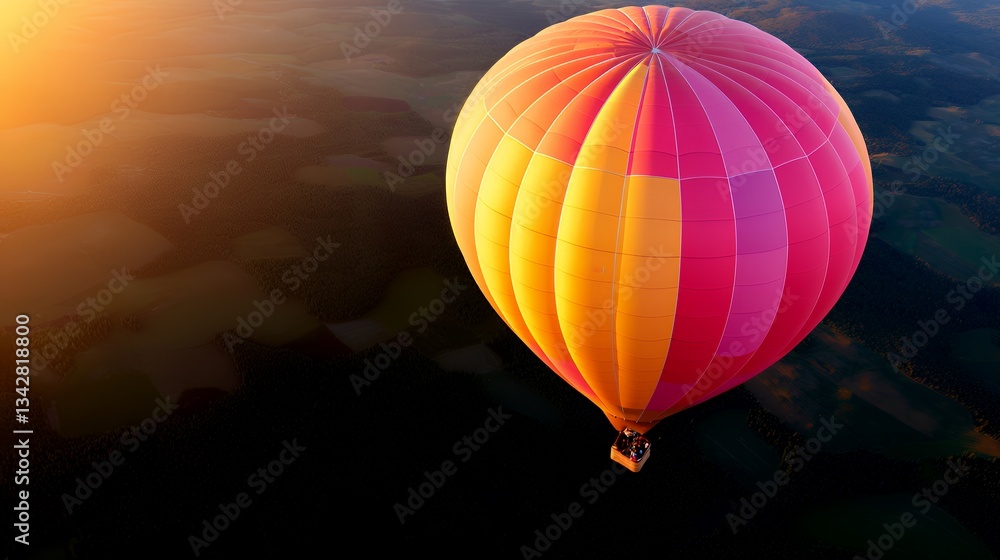 Obraz premium Hot Air Balloon Floating Over Dark Green Landscape at Sunset