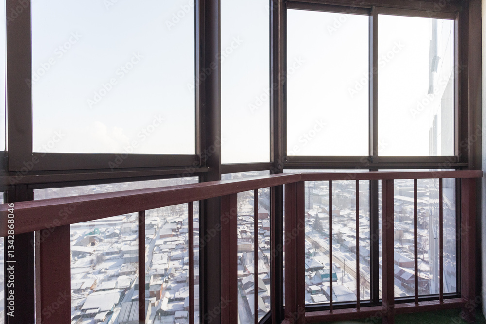 the balcony of an apartment on the upper floors of an apartment building the balcony of an apartment on the upper floors of an apartment building