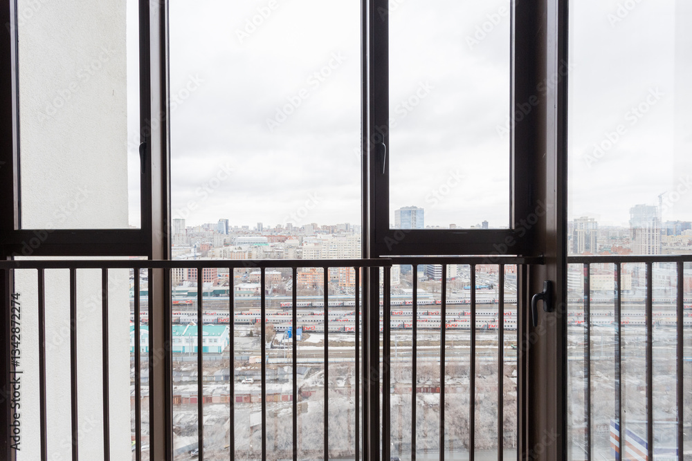 the balcony of an apartment on the upper floors of an apartment building the balcony of an apartment on the upper floors of an apartment building