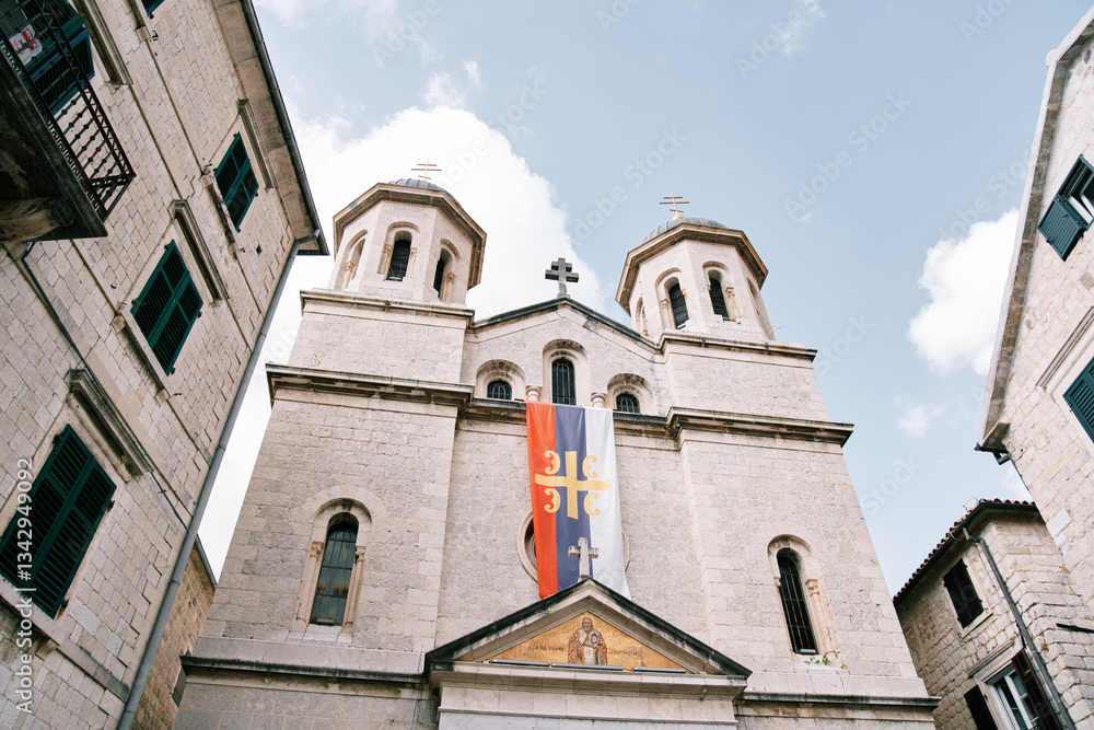 Flag of the Serbian Orthodox Church on the facade of the Church of St. Nicholas in Kotor. Montenegro Flag of the Serbian Orthodox Church on the facade of the Church of St. Nicholas in Kotor. Montenegro
