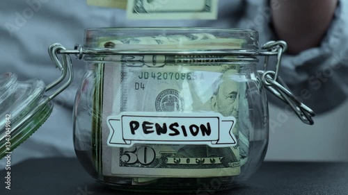 Takes money out of a jar labeled Pension.