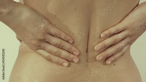 A young woman has back pain