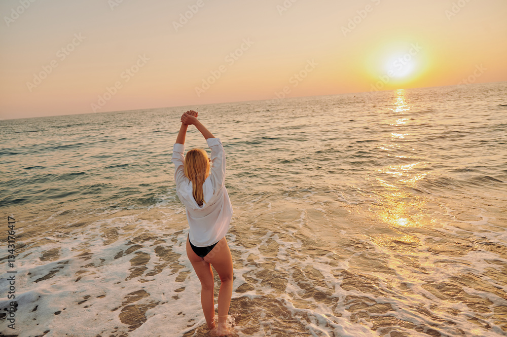 Silhouette of woman standing in sea, enjoying soft waves and golden sunlight. Serene beach atmosphere with warm colors and gentle surf. Ideal for vacation, escape, and tranquility visuals Silhouette of woman standing in sea, enjoying soft waves and golden sunlight. Serene beach atmosphere with warm colors and gentle surf. Ideal for vacation, escape, and tranquility visuals