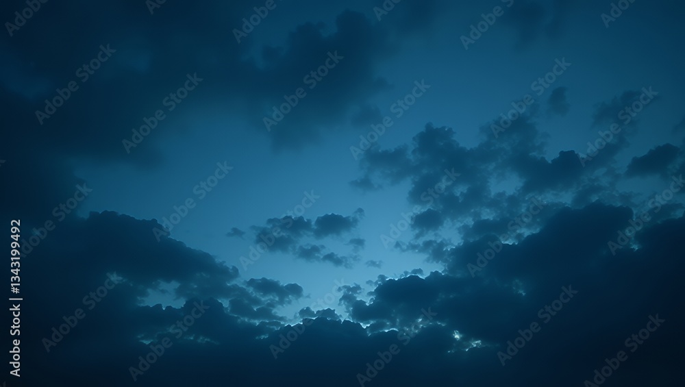 Fototapeta premium Dark blue stormy sky with thick, ominous clouds, dramatic weather, moody and atmospheric, natural scene, cloudy texture, low light
