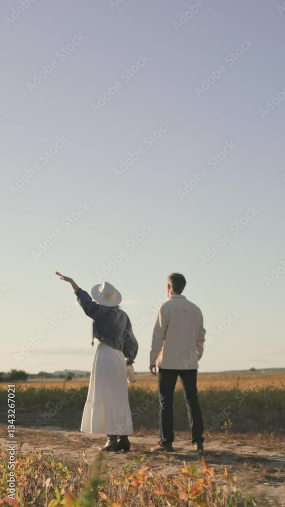 A Couple Delightfully Enjoying a Beautiful Romantic Moment in a Field Surrounded by Nature A Couple Delightfully Enjoying a Beautiful Romantic Moment in a Field Surrounded by Nature