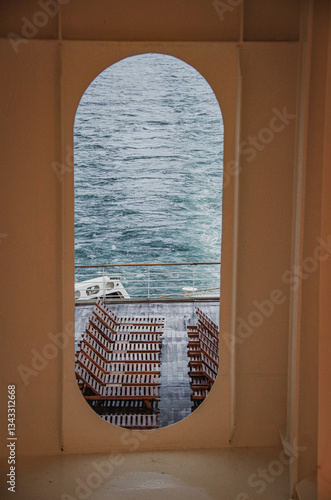 Obraz na płótnie Views onto wet outdoor teak balcony terrace veranda promenade boat deck of ocean liner cruiseship cruise ship with chairs and loungers at sea during Transatlantic Crossing to New York w salonie