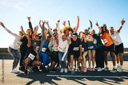 Fototapeta Naklejka Na Ścianę i Meble -  Group of diverse runners celebrating after a community event