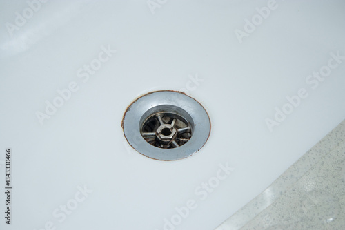 Close up of bathtub dirty metal drain hole with hair and limescale  photo