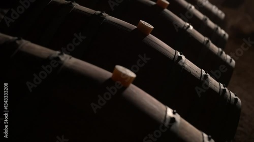 Aged wooden barrels with a wine in a former stone quarry, row of wine barrels at a vintage winery, Wine preparation and fermenting process, High quality 4k footage