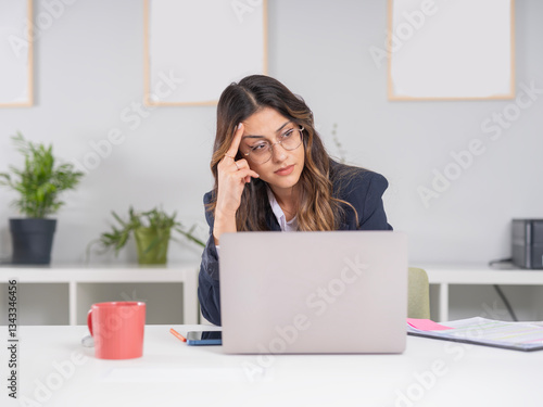 Sad thoughtful businesswoman looking aside, portrait of young caucasian thinking sad thoughtful businesswoman looking aside working in office with laptop computer. Worried about financial success.
