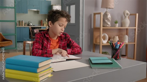 Tired cute teenage African American kid studying with textbook, experiencing difficulties with understanding educational materials and asking for assistance, holding banner with text help.