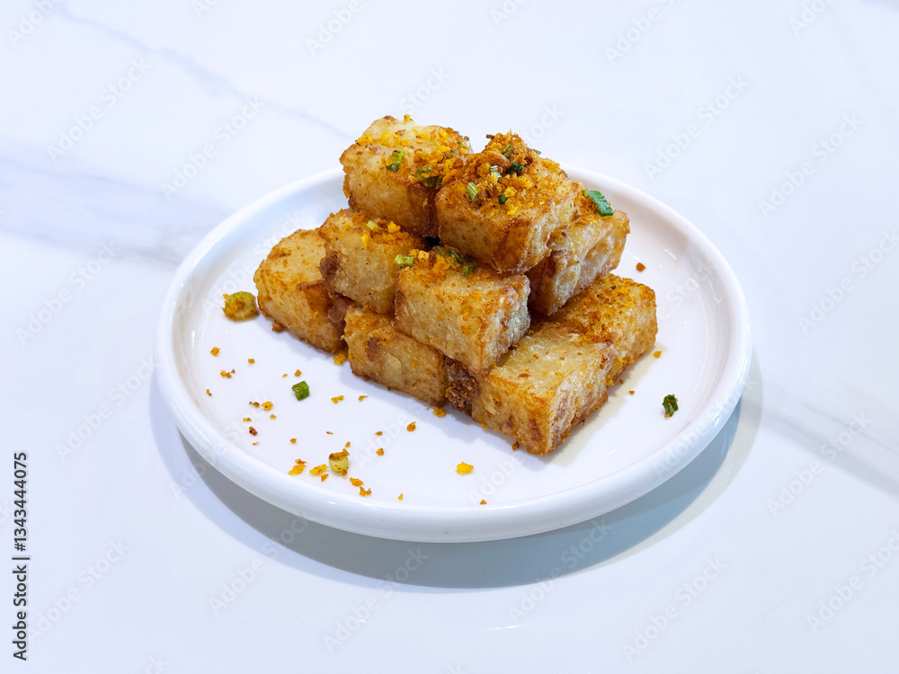 asian deep fried crispy vegetable carrot cake in square w garlic onion spices in plate on marble table chinese dim sum menu banquet restaurant vegan halal food