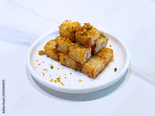 Obraz na płótnie asian deep fried crispy vegetable carrot cake in square w garlic onion spices in plate on marble table chinese dim sum menu banquet restaurant vegan halal food w salonie