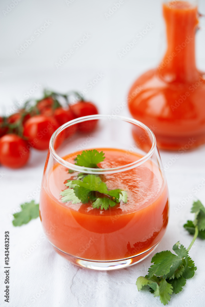 Tomato juice in a glass on a white background Tomato juice in a glass on a white background