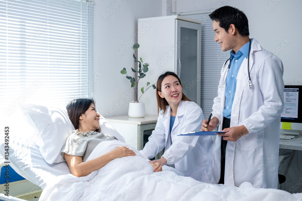 A woman is laying in a hospital bed with two doctors standing over her A woman is laying in a hospital bed with two doctors standing over her