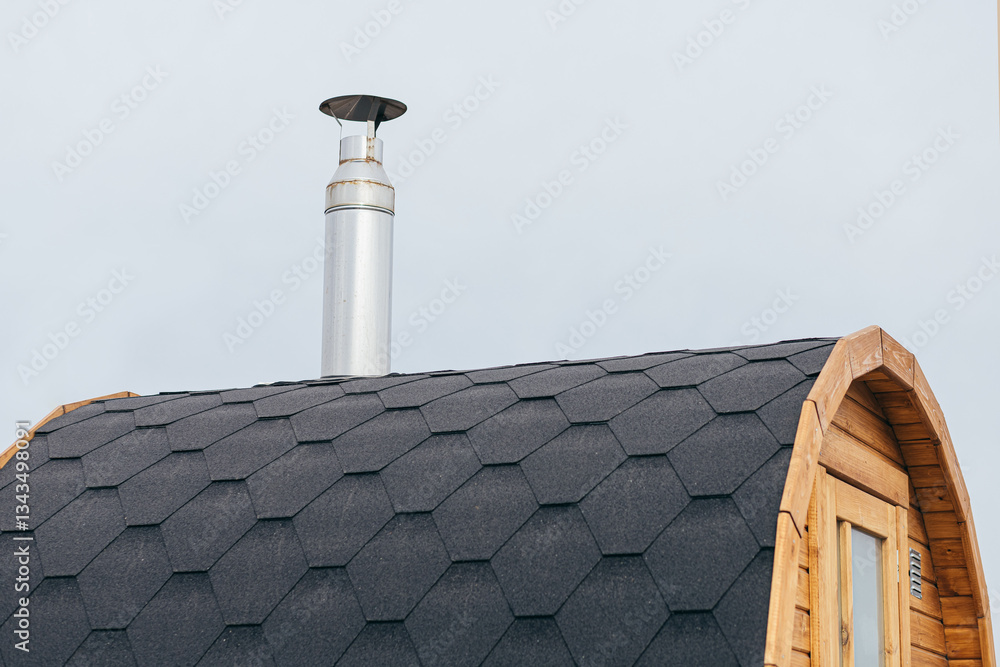 Stainless Steel Chimney Pipe on Arched Asphalt Roof