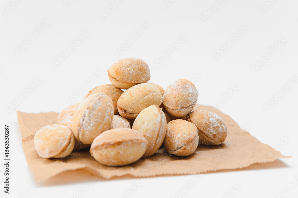 Obraz premium Delicious nut shaped cookies with boiled condensed milk on white background
