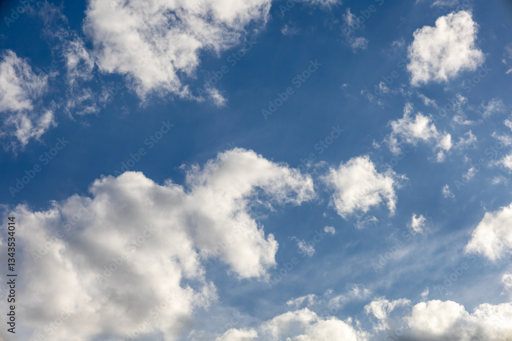 Naklejka premium Blue Sky with Scattered Fluffy Clouds