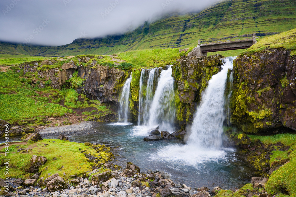 Fototapeta premium Kirkjufellsfoss waterfall near Grundarfjörður at the northern side of the Snæfellsnes Peninsula in West Iceland