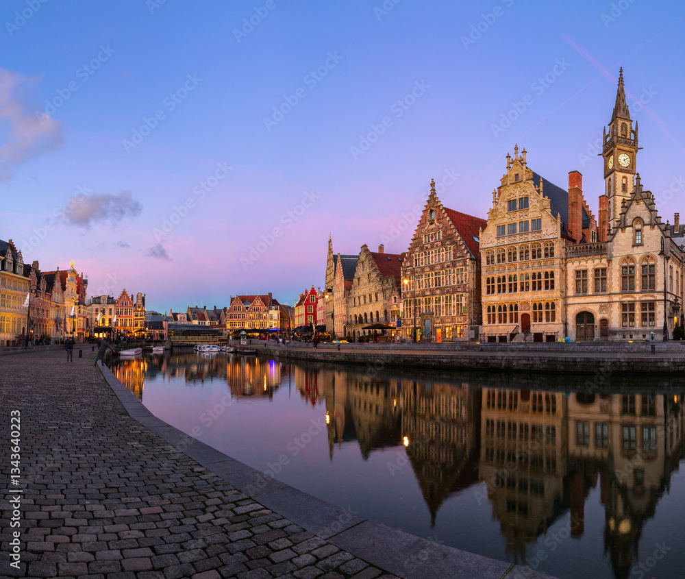 Quay Graslei in Leie river at dusk. Picturesque view of the historical city center of Ghent (Gent), Belgium.
