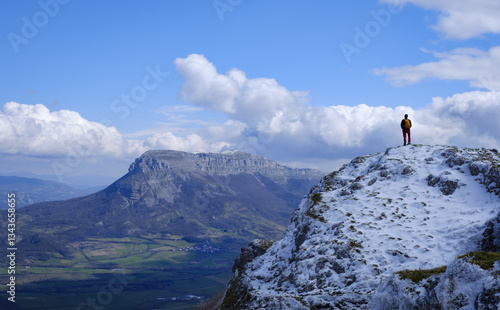 Obraz na płótnie Hiker on Mount Iruaitzeta. Person in the Natural Park of Urbasa and Andia with San Donato mountain in the background, Navarra. w salonie