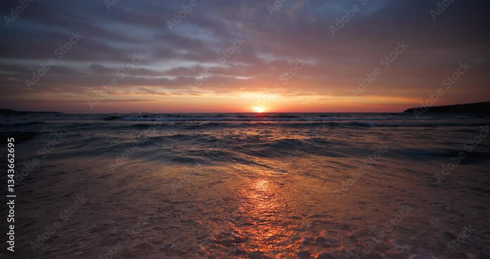 Beautiful dramatic sunrise over the sea waves and beach shore Beautiful dramatic sunrise over the sea waves and beach shore