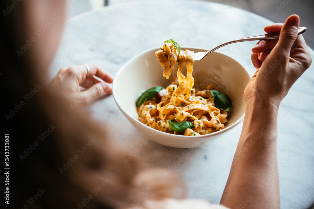 Having a pasta dinner at home or in a restaurant.