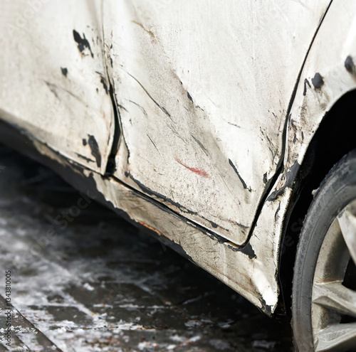 Obraz na płótnie Side view of white car with extensive visible rear door damage, including dents, scuffs, chipped paint, and scratches, aftermath of an accident or collision. Damaged rear door closeup. SELECTIVE FOCUS w salonie
