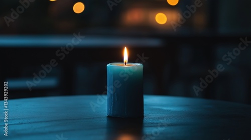 Close-up of a single blue candle on a wooden table. the candle is lit, with the flame burning brightly and casting a warm glow on the surrounding area.