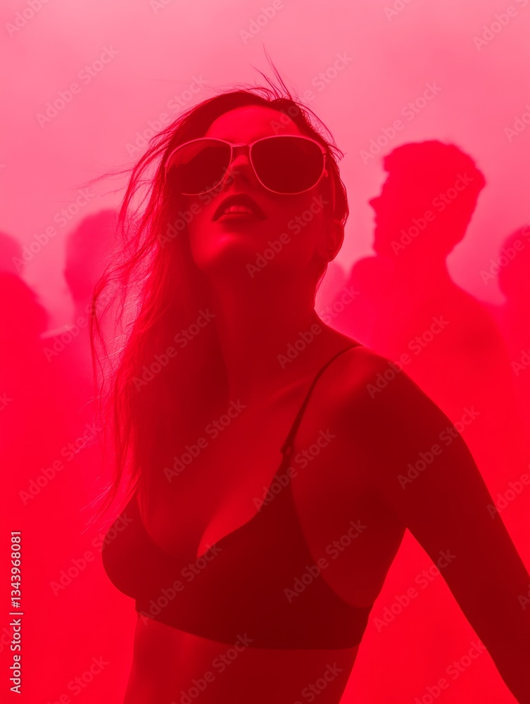 confident woman in sunglasses enjoying vibrant nightclub atmosphere surrounded by neon red lights and dancing silhouettes