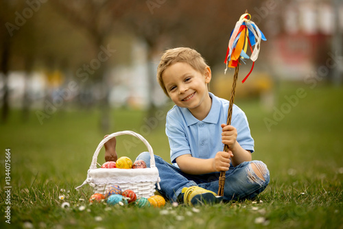 Cute preschool child, whipping his sister on Easter with twig, braided whip made from pussy willow, traditional symbol of Czech Easter used for whipping girls