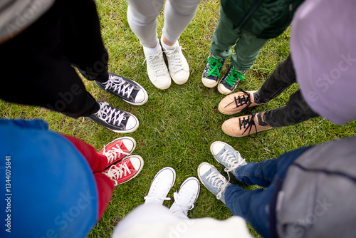 Colorful shoes on children feet. Cool youth colorful white pink green blue black gray gym shoes, people standing in circle, copy place