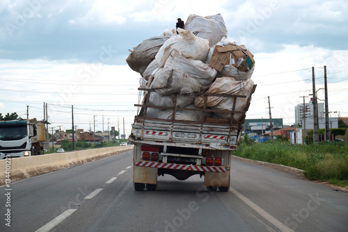 Load securing and traffic hazards. An overloaded truck on a federal highway. The freight of heavy plastic bags was tilted and inadequately secured. Mossoro, Rio Grande do Norte State, Brazil.