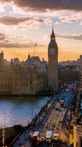 Elevated sunset time lapse view of the Westminster Palace and Big Ben clocktower in London with street and people traffic, England