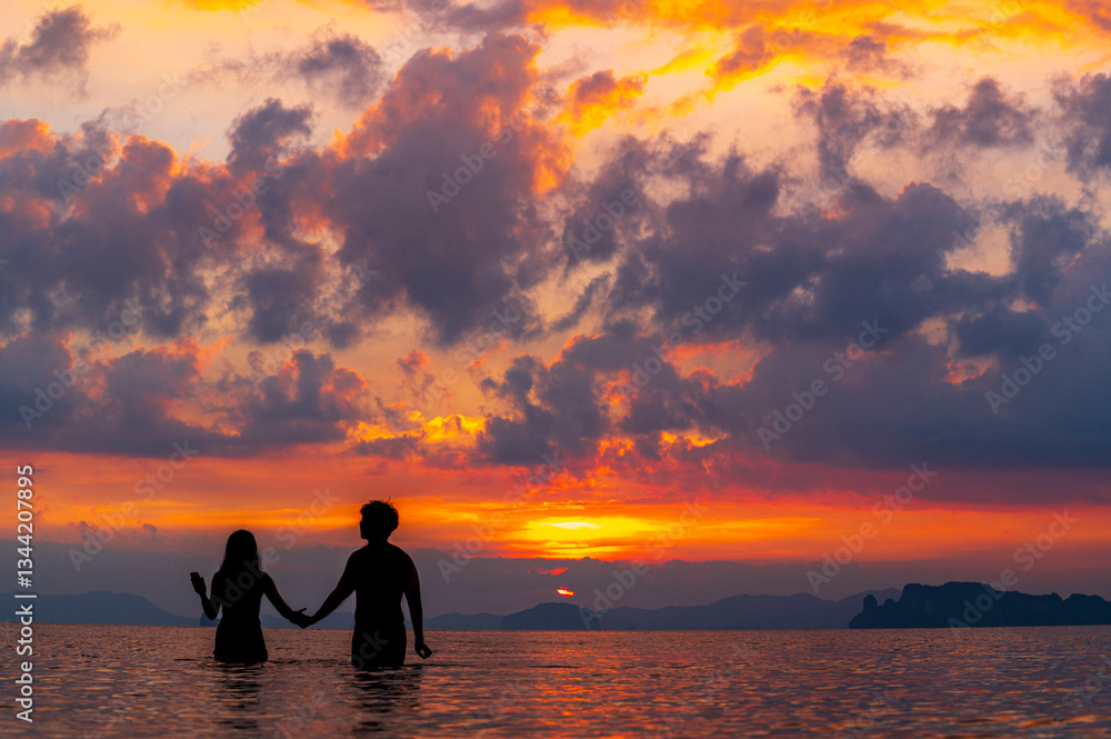 tourist watching sunset or sunrise on beach with seascape and gold lighting sunset sky background