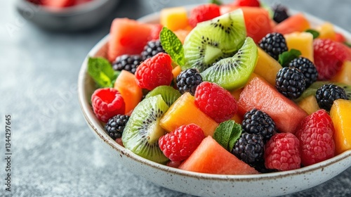 Colorful fruit salad in bowl, fresh ingredients, healthy food concept