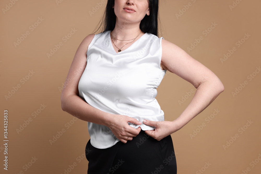 Plus size model on beige background, closeup. Overweight Plus size model on beige background, closeup. Overweight