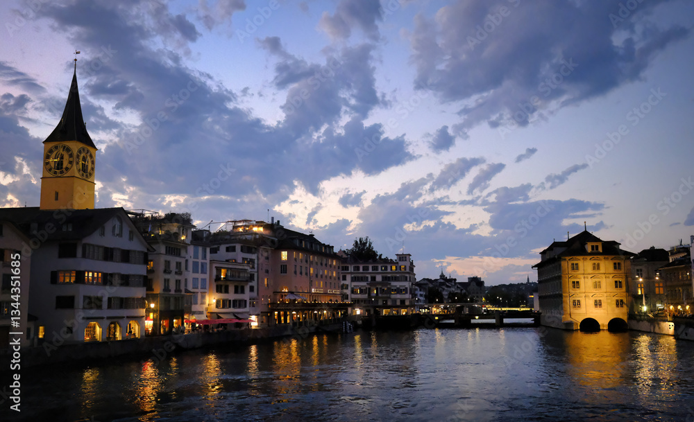 Scenic river view from Munsterbrucke bridge in Zurich Switzerland at sunset. Fraumunster Church tower and Water Church at dusk with clouds in the colorful sky. Scenic river view from Munsterbrucke bridge in Zurich Switzerland at sunset. Fraumunster Church tower and Water Church at dusk with clouds in the colorful sky.
