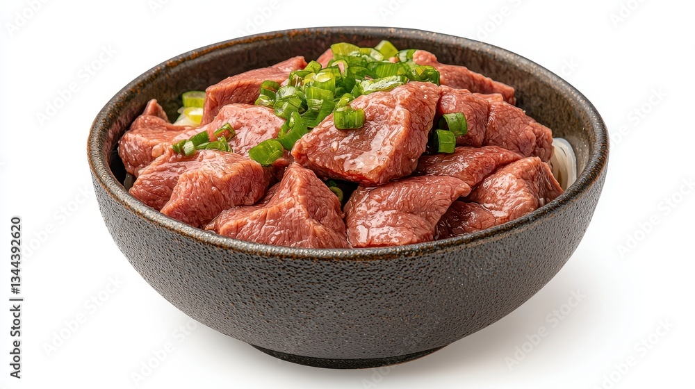 Close-up of savory meat dish in dark bowl, garnished with green onions, set against a bright white background. The reddish-brown m Close-up of savory meat dish in dark bowl, garnished with green onions, set against a bright white background. The reddish-brown m