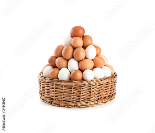 Wallpaper Mural Assorted brown and white eggs in a wicker basket isolated on white background. Torontodigital.ca