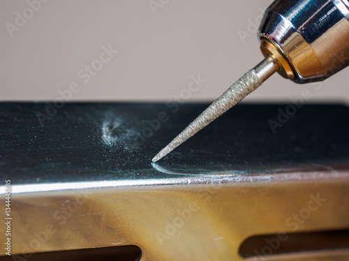 A close-up of an engraver tool, designed for carving into wood and metal. Detailed sharp, precision-focused.