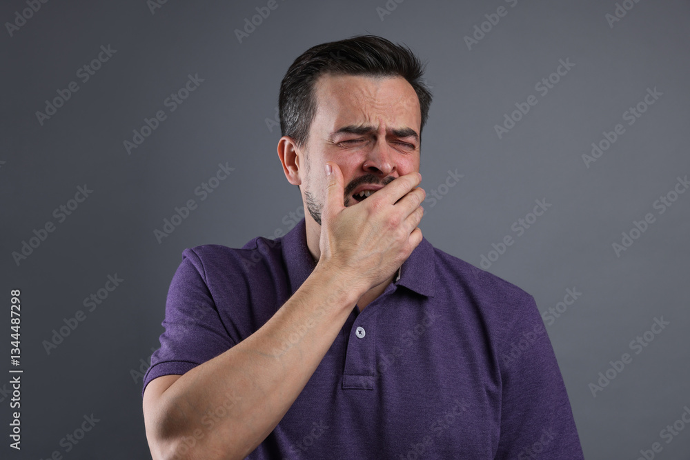 Portrait of sad man crying on grey background Portrait of sad man crying on grey background