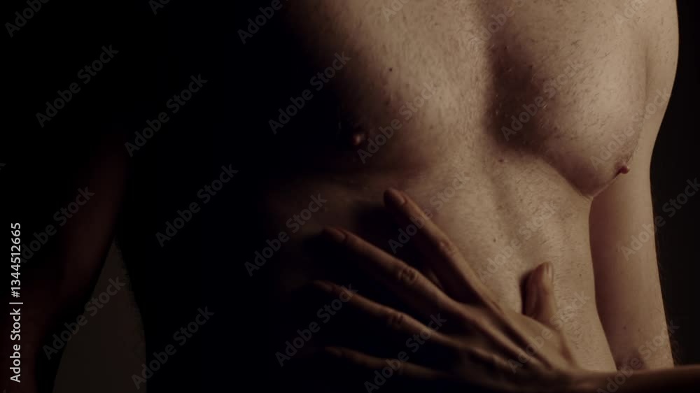 Female hand touching male muscular torso. Slow motion Female hand touching male muscular torso. Slow motion