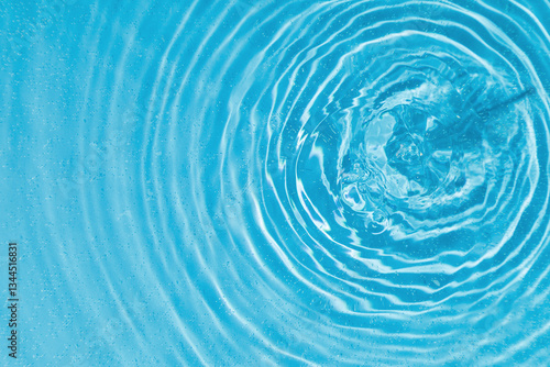 drops on water with circles on a blue background