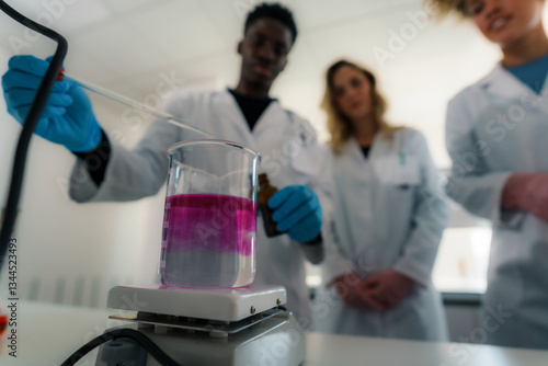 Bild auf Leinwand University chemistry students and professor wearing lab coats and gloves conduct