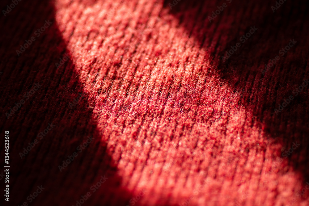 Closeup of a red sweater with shadow accents on its surface Closeup of a red sweater with shadow accents on its surface