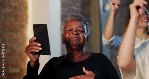 Elderly African woman holding offering envelope during church worship, joyful expression, diverse congregation in background, moment of spiritual faith and unity in sacred space