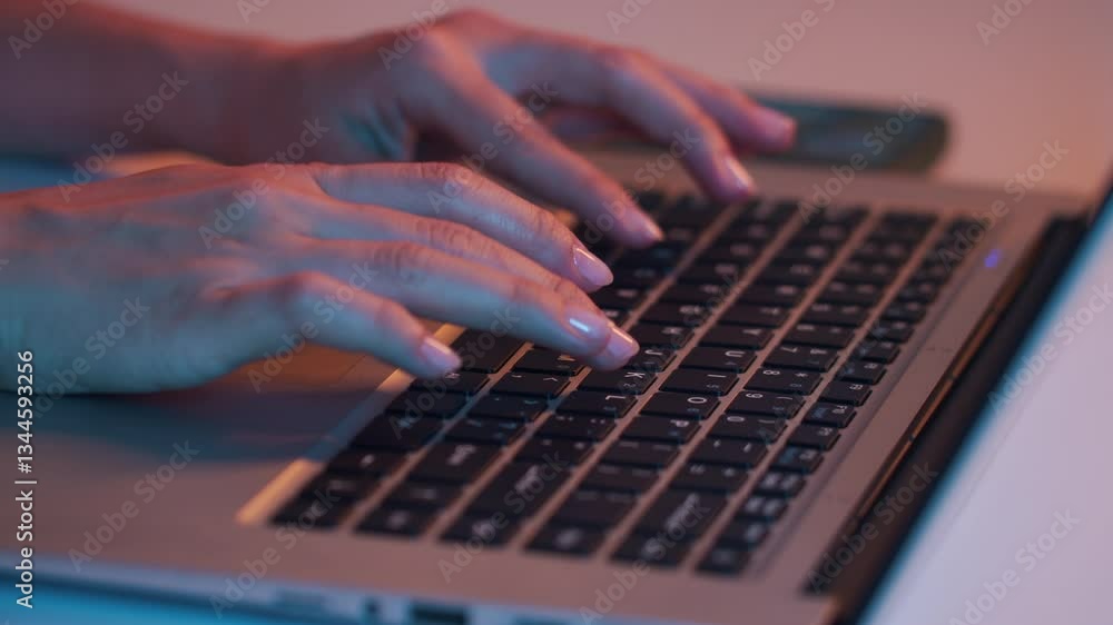 Close up shot of hands of anonymous female user working on wireless laptop in neon Close up shot of hands of anonymous female user working on wireless laptop in neon